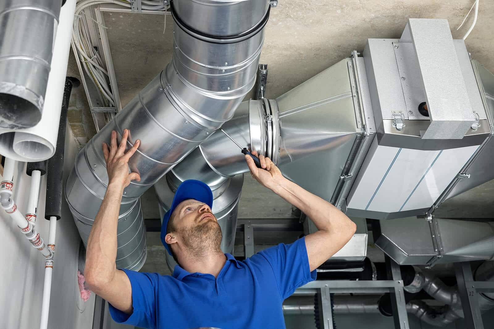 HVAC technician inspecting and repairing air ducts in Manhattan Beach