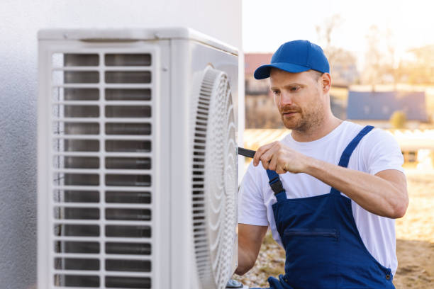 HVAC technician servicing an outdoor air conditioner in Manhattan Beach